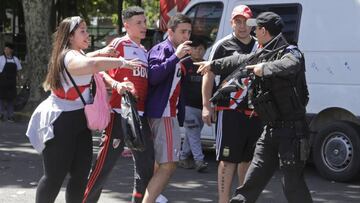 A police officer points at fans of River Plate&#039;s soccer team outside Antonio Vespucio Liberti stadium after the final Copa Libertadores match against rival Boca Juniors was suspended for a second day in a row in Buenos Aires, Argentina, Sunday, Nov. 25, 2018. In one of the most embarrassing weekends in South American football history, the Copa Libertadores final was once more postponed on Sunday. The same decision was made on Saturday after Boca&#039;s bus was attacked by River fans.  (AP Photo/Diego Martinez)