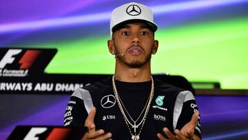Mercedes AMG Petronas F1 Team's British driver Lewis Hamilton gestures during the drivers press conference ahead of the Abu Dhabi Formula One Grand Prix at the Yas Marina circuit on November 24, 2016. / AFP PHOTO / ANDREJ ISAKOVIC