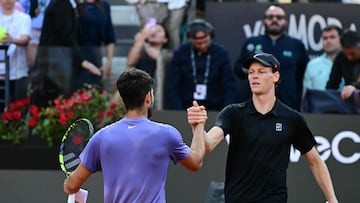 Italy's Jannik Sinner (r) shakes hands with Spain's Carlos Alcaraz (l) at the end of their men's singles final match for the ATP Rome Open tennis tournament at Foro Italico in Rome on May 18, 2025. (Photo by Tiziana FABI / AFP)