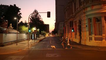 Two women walk their dog during a preventive quarantine following the outbreak of coronavirus disease (COVID-19), in Santiago, Chile, on March 27, 2020. REUTERS/Pablo Sanhueza