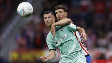 Athletic Bilbao's Spanish forward #11 Gorka Guruzeta fights for the ball with Atletico Madrid's French defender #15 Clement Lenglet during the Spanish league football match between Club Atletico de Madrid and Athletic Club Bilbao at the Metropolitano stadium in Madrid on April 25, 2026. (Photo by Oscar DEL POZO / AFP)