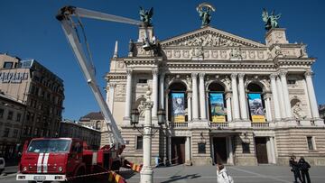 Workers of The State Emergency Service of Ukraine cover the statues on the Opera House with protective materials on March 21, 2022 in Lviv, Ukraine.