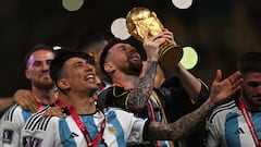 Argentina's captain and forward #10 Lionel Messi lifts the FIFA World Cup Trophy as he celebrate with teammates winning the Qatar 2022 World Cup final football match between Argentina and France at Lusail Stadium in Lusail, north of Doha on December 18, 2022. (Photo by Paul ELLIS / AFP)