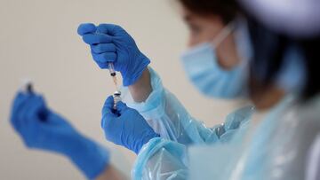 A health worker fills a syringe with a dose of the Pfizer-BioNTech coronavirus disease (COVID-19) vaccine at the Noevir Stadium Kobe, the home venue of Japanese professional soccer club Vissel Kobe and currently acting as a large-scale COVID-19 vaccination center, in Kobe, Japan June 12, 2021. REUTERS/Issei Kato