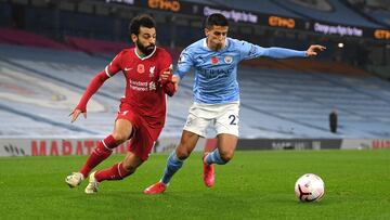 MANCHESTER, ENGLAND - NOVEMBER 08: Joao Cancelo of Manchester City battles for possession with Mohamed Salah of Liverpool during the Premier League match between Manchester City and Liverpool at Etihad Stadium on November 08, 2020 in Manchester, England. 