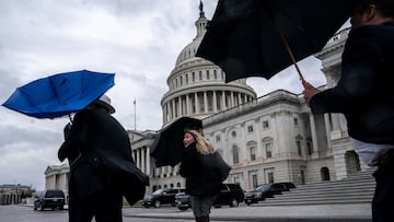 People react to strong wind while walking near the U.S. Capitol, in Washington, U.S., February 27, 2024. REUTERS/Nathan Howard