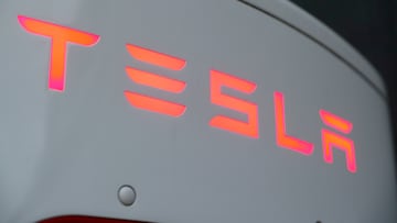 The logo of Tesla is seen at a Tesla Supercharger station October 21, 2020. REUTERS/Arnd Wiegmann/File Photo