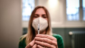 A medical staff member prepares a syringe with a dose of the Pfizer-BioNTech Covid-19 vaccine at a temporary vaccination center in Paris, on November 27, 2021, amid the Covid-19.