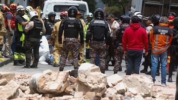 Soldiers and firefighters work at the place where the cornice and terrace of a building located in Cuenca's historic center fell and destroyed a car, leaving one dead and one person injured, after an earthquake in Cuenca, Ecuador on March 18, 2023. - Four dead in southern Ecuador and damage to buildings after an earthquake with an epicenter in that country, which reached its neighbor Peru, according to a preliminary balance of authorities. The earthquake of magnitude 6.5 in Ecuador and 7.0 in Peru was recorded at 12:12 local time (17:12 GMT) in the Ecuadorian municipality of Balao, about 140 kilometers from the port of Guayaquil, and at a depth of 44 kilometers, authorities reported. (Photo by FERNANDO MACHADO / AFP) (Photo by FERNANDO MACHADO/AFP via Getty Images)