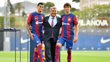 João Félix y João Cancelo con el presidente del Barcelona, Joan Laporta, durante su presentación.