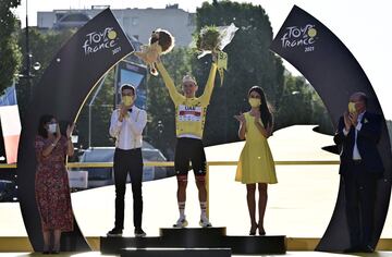 El ganador del equipo UAE Emirates, Tadej Pogacar de Eslovenia, celebra su maillot amarillo de líder general en el podio junto a la alcaldesa de París Anne Hidalgo