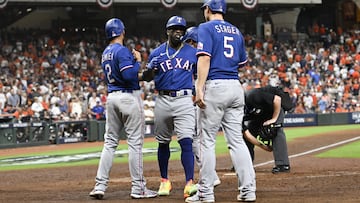 Houston (United States), 23/10/2023.- Texas Rangers Adolis Garcia (C) is greeted at home plate by Texas Rangers second baseman Marcus Semien (L), Texas Rangers Corey Seager (R), and Texas Rangers Leody Taveras (background) after hitting a grand slam (four run home run) off Houston Astros relief pitcher Ryne Stanek during the ninth inning of game six of the Major League Baseball (MLB) American League Championship Series playoffs between the Texas Rangers and Houston Astros at Minute Maid Park in Houston, Texas, USA, 22 October 2023. The League Championship Series is the best-of-seven games. The Astros lead the Rangers 3-2. (Liga de Campeones) EFE/EPA/KEN MURRAY