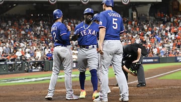 Houston (United States), 23/10/2023.- Texas Rangers Adolis Garcia (C) is greeted at home plate by Texas Rangers second baseman Marcus Semien (L), Texas Rangers Corey Seager (R), and Texas Rangers Leody Taveras (background) after hitting a grand slam (four run home run) off Houston Astros relief pitcher Ryne Stanek during the ninth inning of game six of the Major League Baseball (MLB) American League Championship Series playoffs between the Texas Rangers and Houston Astros at Minute Maid Park in Houston, Texas, USA, 22 October 2023. The League Championship Series is the best-of-seven games. The Astros lead the Rangers 3-2. (Liga de Campeones) EFE/EPA/KEN MURRAY
