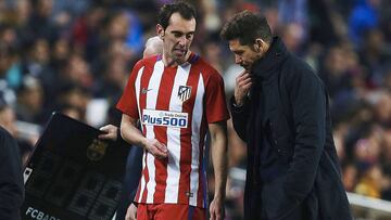 Diego Godín (l) went off injured against Barcelona on Tuesday