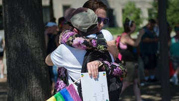 A woman offers free hugs in Washington, DC on June 12, 2016, in reaction to the mass shootings at a gay club in Orlando, Florida.
 A somber President Barack Obama  expressed grief and outrage at the &quot;horrific massacre&quot; of 50 late-night revelers at an Orlando gay club, branding it an act of terror and hate. / AFP PHOTO / ANDREW CABALLERO-REYNOLDS