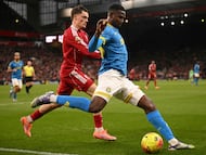 Wolverhampton Wanderers' Colombian defender #15 Yerson Mosquera (R) vies with Liverpool's German midfielder #07 Florian Wirtz (L) during the English Premier League football match between Liverpool and Wolverhampton Wanderers at Anfield in Liverpool, north west England on December 27, 2025. (Photo by Oli SCARFF / AFP) / RESTRICTED TO EDITORIAL USE. No use with unauthorized audio, video, data, fixture lists, club/league logos or 'live' services. Online in-match use limited to 120 images. An additional 40 images may be used in extra time. No video emulation. Social media in-match use limited to 120 images. An additional 40 images may be used in extra time. No use in betting publications, games or single club/league/player publications. /