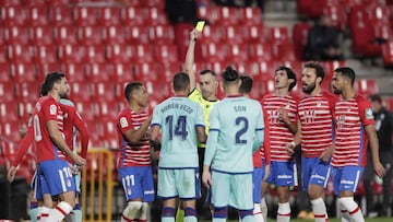 GRANADA, SPAIN - NOVEMBER 01: Referee Santiago Jaime Latre awards Ruben Vezo of Levante UD a yellow card during the La Liga Santader match between Granada CF and Levante UD at Estadio Nuevo Los Carmenes on November 01, 2020 in Granada, Spain. Football Sta