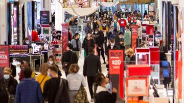 (FILES) In this file photo taken on November 27, 2020, customers shop at Macyx92s department store in New York on Black Friday. - US personal income plunged 7.1 percent in February as the effect of stimulus checks approved late last year faded, the US Com