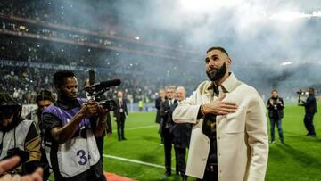 Real Madrid's French forward Karim Benzema gestures to fans during the presentation of his Ballon d'Or trophy at half time of the French L1 football match between Olympique Lyonnais (OL) and OGC Nice at The Groupama Stadium in Decines-Charpieu, central-eastern France, on November 11, 2022. (Photo by OLIVIER CHASSIGNOLE / AFP) (Photo by OLIVIER CHASSIGNOLE/AFP via Getty Images)