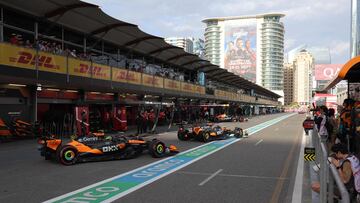 McLaren's Australian driver Oscar Piastri and McLaren's British driver Lando Norris ride in the pits during a qualifying session of the Formula One Azerbaijan Grand Prix at the Baku City Circuit in Baku on September 20, 2025. (Photo by Anton Vaganov / AFP)