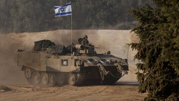 An Israeli soldier rides in an armoured personnel carrier (APC) near the border with Gaza, after a temporary truce between Israel and the Palestinian Islamist group Hamas expired, in Israel, December 1, 2023. REUTERS/Amir Cohen