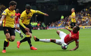 Martial is challenged by Watford's Miguel Britos before Etienne Capoue (not pictured) scores their first goal.