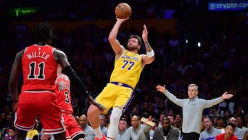 Los Angeles Lakers guard Luka Doncic (77) shoots against Chicago Bulls guard Josh Giddey (3) and forward Leonard Miller (11) during the first half at Crypto.com Arena.