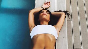 Pilar Rubio en bikini tomando el sol al borde de una piscina.