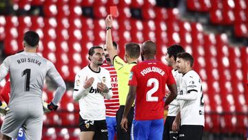 GRANADA, SPAIN - DECEMBER 30: Jason of Valencia CF is shown a red card by Referee Adrian Cordero Vega during the La Liga Santander match between Granada CF and Valencia CF at Estadio Nuevo Los Carmenes on December 30, 2020 in Granada, Spain. Sporting stad