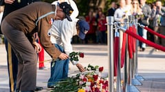 Darrell Bush, 96, left, a former US Army Staff Sgt., from Camp Springs, Maryland, and a WWII veteran of the Battle of the Bulge, places a flower with his wife Dorothy Bush, during a centennial commemoration event at the Tomb of the Unknown Soldier, in Arl