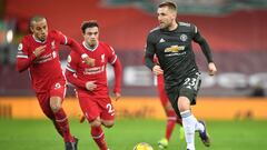 Manchester United&#039;s English defender Luke Shaw (R) runs away from Liverpool&#039;s Spanish midfielder Thiago Alcantara (L) during the English Premier League football match between Liverpool and Manchester United at Anfield in Liverpool, north west En