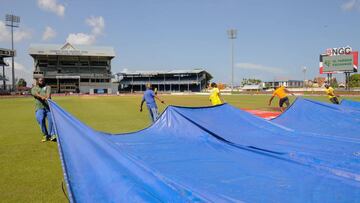 Grounds crew pull a tarp over the field August 22, 2016 as play is abandoned on day 5 of the 4th and final Test between West Indies and India at Queen's Park Oval in Port of Spain, Trinidad and Tobago.