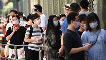People queue outside a Covid testing centre in Hong Kong on November 22, 2020 as a spike in Covid 19 cases brings in tighter restrictions and forcing a planned travel bubble between Hong Kong and Singapore to be scrapped a day before its launch on November 21. (Photo by Peter PARKS / AFP)