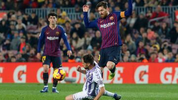 Barcelona's Argentinian forward Lionel Messi (R) vies for the ball with Real Valladolid's Spanish midfielder Michel during the Spanish League football match between Barcelona and Real Valladolid at the Camp Nou stadium in Barcelona on February 1