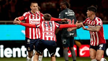 Guadalajara's forward #25 Roberto Alvarado (L) celebrates with teammate midfielder #50 Mateo Chavez after scoring during the Liga MX Clausura football match between Guadalajara and Tijuana at the Akron stadium in Zapopan, Jalisco state, Mexico on February 9, 2025. (Photo by Ulises Ruiz / AFP)
