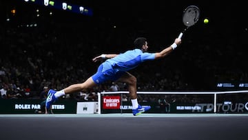 Serbia's Novak Djokovic plays a forehand return to Bulgaria's Grigor Dimitrov during their men's singles final match of the Paris ATP Masters 1000 tennis tournament at the Accor Arena - Palais Omnisports de Paris-Bercy - in Paris on November 5, 2023. (Photo by JULIEN DE ROSA / AFP)