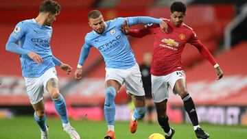 Manchester United&#039;s English striker Marcus Rashford (R) vies with Manchester City&#039;s English defender Kyle Walker (C) and Manchester City&#039;s English defender John Stones (L) during the English Premier League football match between Manchester 