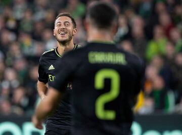 Hazard (left) celebrates with team-mate Dani Carvajal after scoring Real Madrid's third against Celtic.