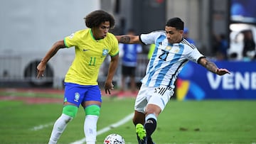 Brazil's Biro (L) and Argentina's Ezequiel Fernandez (R) fight for the ball during the Venezuela 2024 CONMEBOL Pre-Olympic Tournament football match between Brazil and Argentina at the Brigido Iriarte stadium in Caracas on February 5, 2024. (Photo by Federico Parra / AFP)