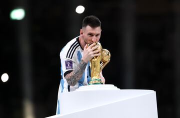 Messi besa la Copa del Mundo tras recibir el premio al Mejor Jugador del torneo.