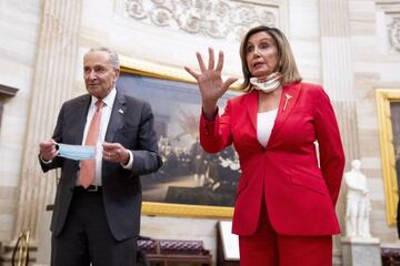 US Speaker of the House Nancy Pelosi (R) and US Senate Minority Leader Democrat Chuck Schumer (L) respond to questions from members of the news media in the Capital Rotunda.