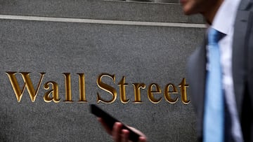 FILE PHOTO: A man walks on Wall Street outside the New York Stock Exchange (NYSE) in New York City, U.S., April 7, 2025. REUTERS/Brendan McDermid/File Photo