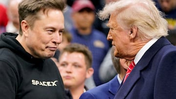 FILE PHOTO: Tesla CEO Elon Musk greets U.S. President Donald Trump as they attend the NCAA men's wrestling championships in Philadelphia, Pennsylvania, U.S., March 22, 2025. REUTERS/Nathan Howard/File Photo NO RESALES. NO ARCHIVES