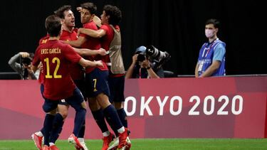 Spain's forward Mikel Oyarzabal (2nd L) is celebrated by teammates on his goal during the Tokyo 2020 Olympic Games men's group C first round football match between Australia and Spain at Sapporo Dome in Sapporo on July 25, 2021. (Photo by ASANO