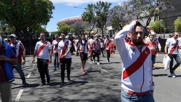 River Plate's supporters leave the Monumental stadium in Buenos Aires, after the all-Argentine Copa Libertadores second leg final match against Boca Juniors was postponed on November 25, 2018. - The second leg of the Copa Libertadores final has been postponed for the second time in as many days following an attack on the Boca Juniors team bus by River Plate fans, Conmebol said Sunday. (Photo by Juan Mabromata / AFP)