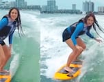 Shakira shows off her surfing skills again and gives a sneak peak of a new song