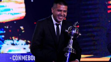 Soccer Football - Copa Libertadores 2020 Draw - CONMEBOL Headquarters - Luque, Paraguay - December 17, 2019   Boca Juniors legend Juan Roman Riquelme receives a replica of the Libertadores trophy during the draw  REUTERS/Jorge Adorno