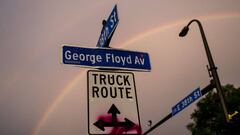 A decal pasted onto a street sign marks &quot;George Floyd Avenue&quot; as a rainbow sprawls across the sky over a memorial site at 38th St and Chicago Avenue on June 18, 2020 in Minneapolis, Minnesota.