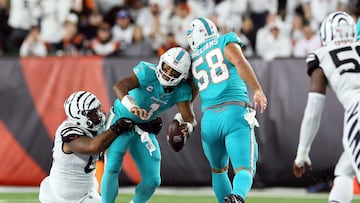 CINCINNATI, OHIO - SEPTEMBER 29: Quarterback Tua Tagovailoa #1 of the Miami Dolphins is sacked by defensive tackle Josh Tupou #68 of the Cincinnati Bengals during the 2nd quarter of the game against the Cincinnati Bengals at Paycor Stadium on September 29, 2022 in Cincinnati, Ohio.   Andy Lyons/Getty Images/AFP