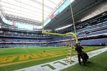 Workers install the posts on each side of the field at the Bernabéu stadium.